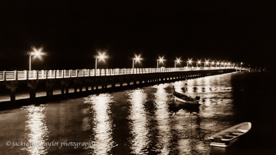 lighted pier at night B/W 16x9